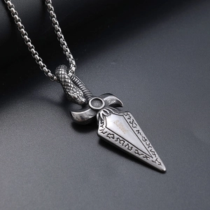 Macro shot of stainless steel Viking snake spearhead pendant with vintage relief details