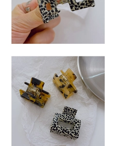 Detail of square acetate hair claw clips with leopard and tortoiseshell patterns