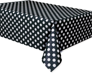 Detailed view of black disposable tablecloth with white polka dot pattern for racing parties