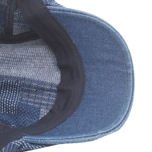 Detail of inner brim and sweatband on a dark blue denim beret with precise stitching