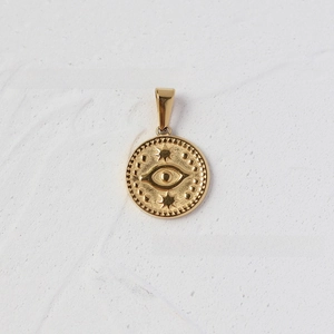 Detail of 18K gold plated stainless steel evil eye pendant with star relief and beaded edge