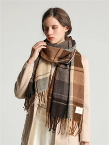 Detail shot of brown plaid scarf with soft fringe and professional brand label