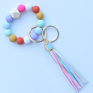 Detail of colorful leopard silicone beads and wooden bead keychain with leather tassel