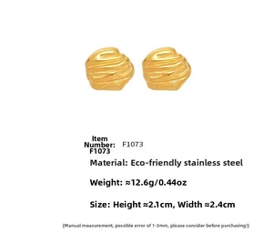 Detailed view of chunky irregular texture golden earrings with product specifications