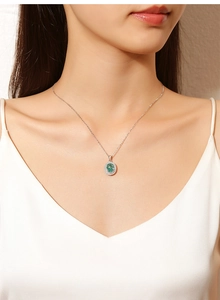 Detailed view of an oval Paraiba gemstone pendant with a halo setting on a silver chain