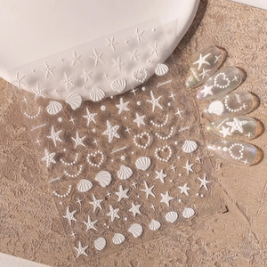 5D embossed marine nail stickers with starfish and shells displayed on beach-style props