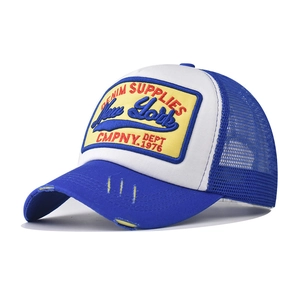 Detail of blue and white trucker hat with 3D embroidery and distressed vintage brim