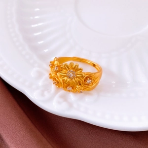 Macro detail of vintage gold floral ring with sparkling diamonds and matte finish