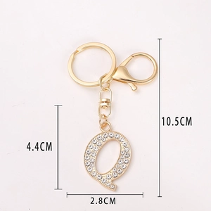 Gold letter Q keychain with rhinestones showing dimensions 10.5cm length and 4.4cm height