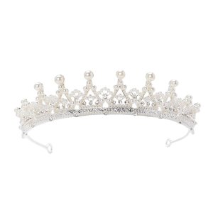 Elegant silver bridal crown with white pearls and sparkling rhinestones on white backdrop