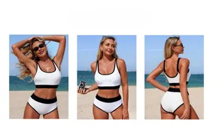 Three-way view of white bikini set with black trim and eyelet fabric on a sunny beach