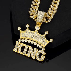 Iced out gold KING crown pendant on a sparkling Cuban link chain for hip hop style