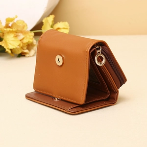 Detailed interior view of caramel leather tri-fold wallet with card slots and golden snap