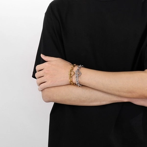 Detail view of heart-shaped toggle clasp on chunky stainless steel chain bracelet for men