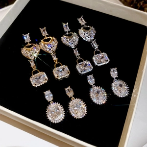Exquisite square zircon earrings and heart pendant set displayed on black velvet box