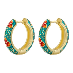 Close-up of golden C-shaped floral earrings with green enamel and red flower details