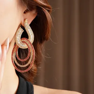 Luxury layered geometric circle drop earrings with pink zircons on elegant model