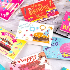 Close-up of vintage kraft paper birthday cards with dried flowers and festive patterns