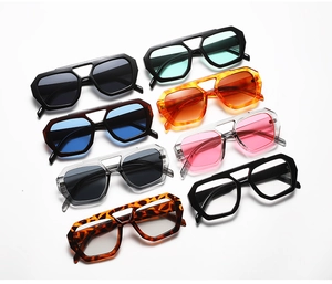 Flat lay of geometric double bridge sunglasses in multiple colors and frame patterns