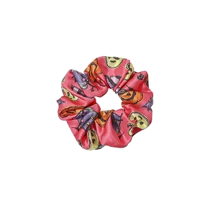 Pink satin Halloween scrunchie featuring festive pumpkin, bat, and smiling face patterns