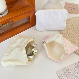 Three quilted lace cosmetic bags for makeup storage including white, beige and pink colors
