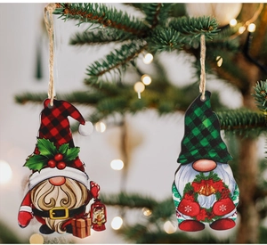 Close-up of red and green plaid gnome ornaments hanging on a Christmas tree with bokeh lights