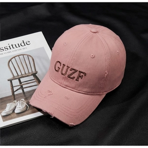 Detail of vintage pink cotton baseball cap with 3D GUZF embroidery and distressed edges