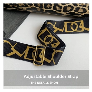 Detail of adjustable nylon strap with leopard print and gold metal buckle on shoulder bag