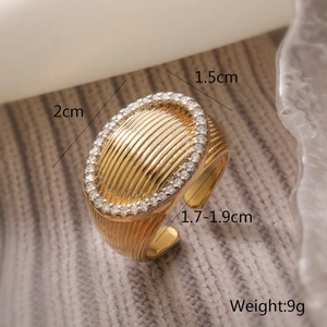Macro shot of gold-plated geometric ring with relief texture and pavé zircon edges