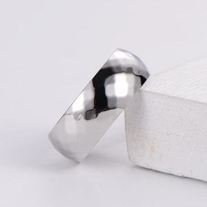 Macro shot of silver stainless steel Mobius ring with geometric diamond-cut facets