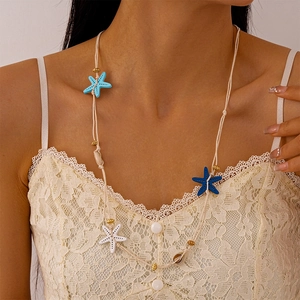 Handmade woven necklace with blue starfish and seashells for summer beach vacation style