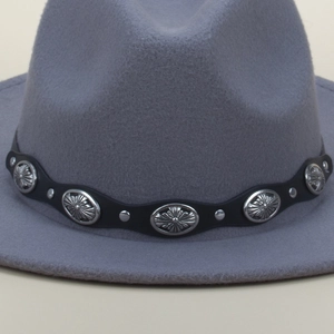 Detail of grey fedora featuring black leather band with silver conchos and punk rivets