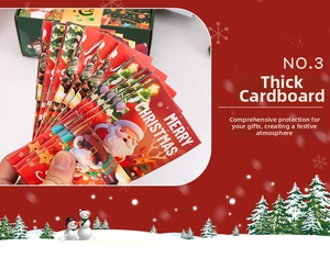 Détail d'une boîte cadeau de Noël en carton rouge avec motifs de Père Noël festifs