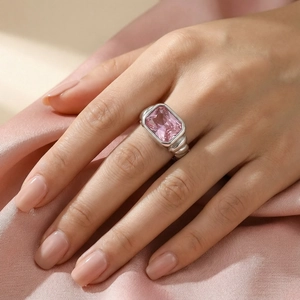 Detail view of a French twist silver ring with a rectangular pink stone on silk