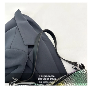 Close-up of sparkling green and yellow gradient sequins on stylish leather shoulder bag