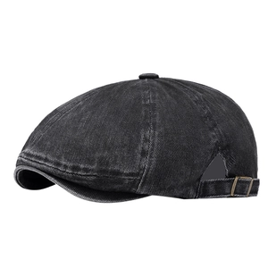 Vintage black washed denim newsboy cap with retro metallic adjustment buckle on white background