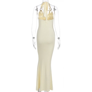 Detail of the backless halter dress with cross lace-up ties and fishtail hem in light yellow