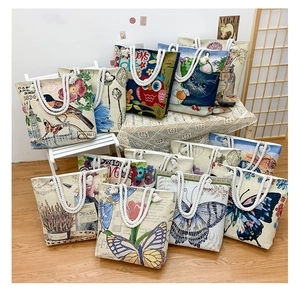 Detailed view of assorted canvas tote bags with vintage prints and cotton rope handles