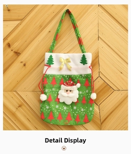 Detail of green fabric Christmas gift bag with Santa Claus 3D applique and white fur trim