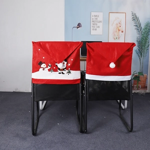 Detail view of red Christmas chair covers with snowman and penguin prints in home setting