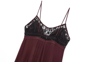 Detailed view of dark burgundy satin fabric with exquisite black floral lace trim and zipper