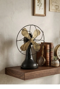 Detail of vintage industrial decorative fan with rustic brass blades on a wooden shelf