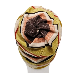 Detail of multi-color striped knitted beanie with textured pattern on a model head