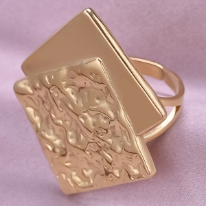 Detailed macro view of adjustable rose gold ring with smooth and hammered metal textures