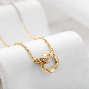 Close-up of interlocking Mobius loops gold necklace with sparkling zircon stone accents