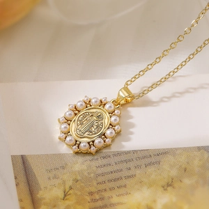 Gold plated oval pendant necklace with pearls and religious relief on a dainty chain