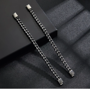 Detail of multi-layer box chain bracelets in gunmetal finish with magnetic clasps