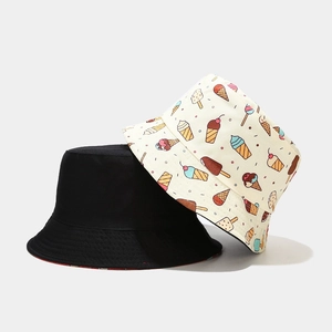 Dual-sided bucket hat featuring cute cartoon ice cream prints and solid black cotton canvas
