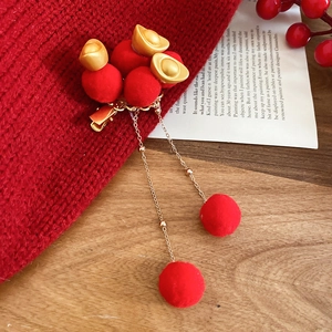 Detailed view of New Chinese Style hair clip with red pom-poms and golden tassels