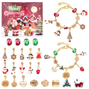 Christmas jewelry advent calendar set with two gold bracelets and 22 festive charms